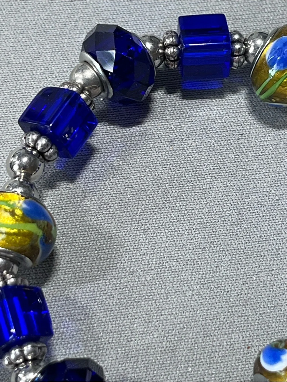 NWOT beautiful blue and yellow plastic beads with silver tone beads in between.